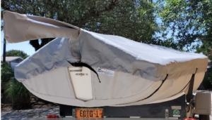 The Lido 14 bottom cover is made from either Sunbrella or Top Gun Fabric. It completely covers the bottom and has straps to secure it. Great to keep road grime off.